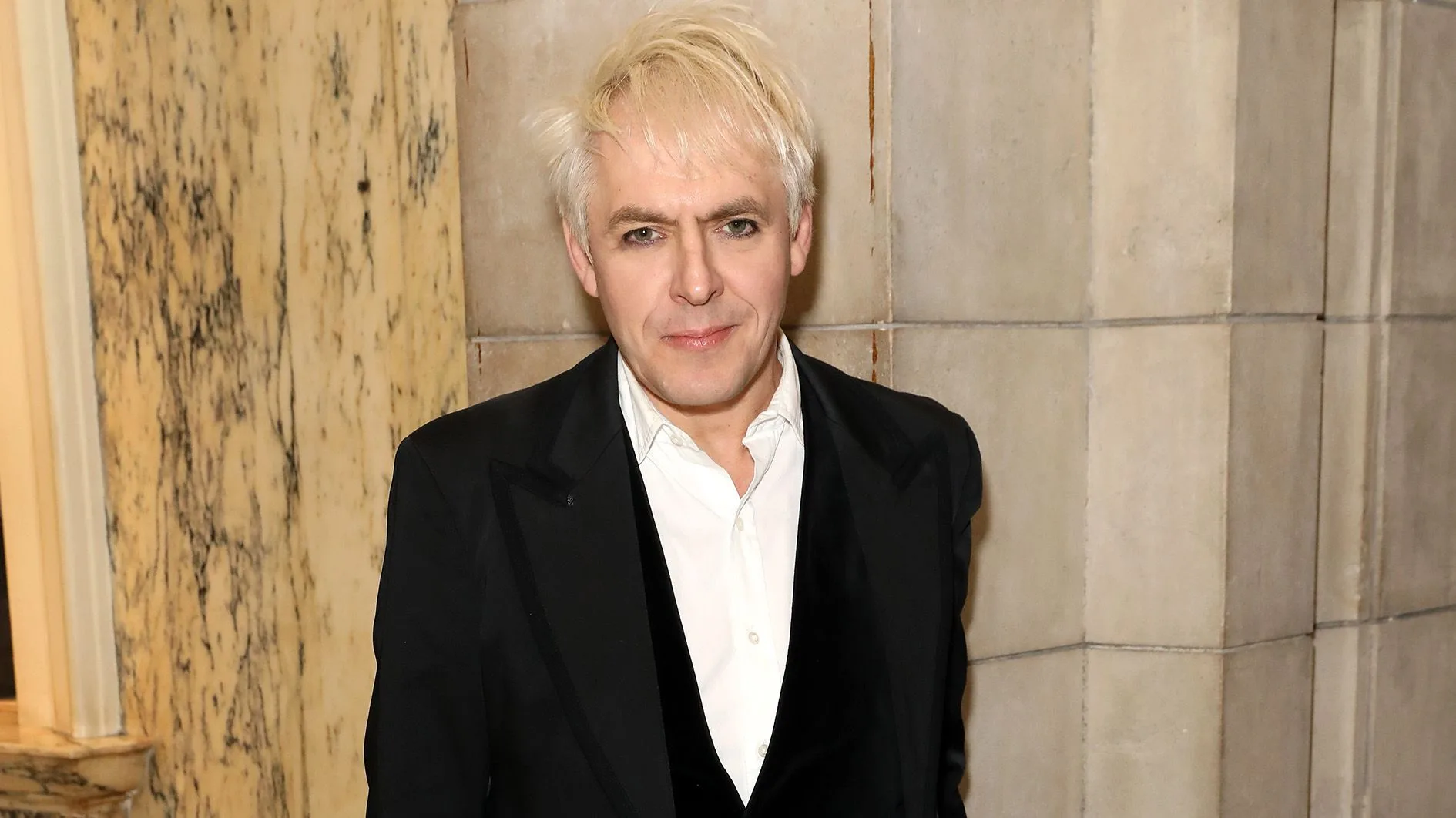 Nick Rhodes, born Nicholas James Bates on June 8, 1962, in Birmingham, England, is the iconic keyboardist and a founding member of the legendary band Duran Duran. Renowned for his groundbreaking work with synthesizers, Rhodes played a vital role in crafting Duran Duran's signature sound since the band's formation in the late 1970s. In addition to his success with Duran Duran, Nick Rhodes has explored creative side projects like Arcadia and The Devils and has gained recognition as a talented producer for various artists.