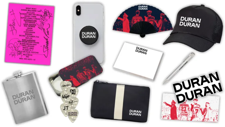 🧢 Mesh Trucker Hat with the Duran Duran logo 🎋 Bamboo Fan with band photo 🥃 Stainless Steel Hip Flask (cheers to that) 🖊 Logo Ballpoint Pen for signing autographs (even if just your own) 📱 Pop Socket, Sticky Notes, Tattoos 🎧 Travel Kit 🎸 Tin of Guitar Picks with band images, logos, and signatures 🎶 Reproduction of the signed setlist from their Dance Macabre show at Madison Square Garden Basically, it’s like a mini Duran shrine in a box. You’re welcome.